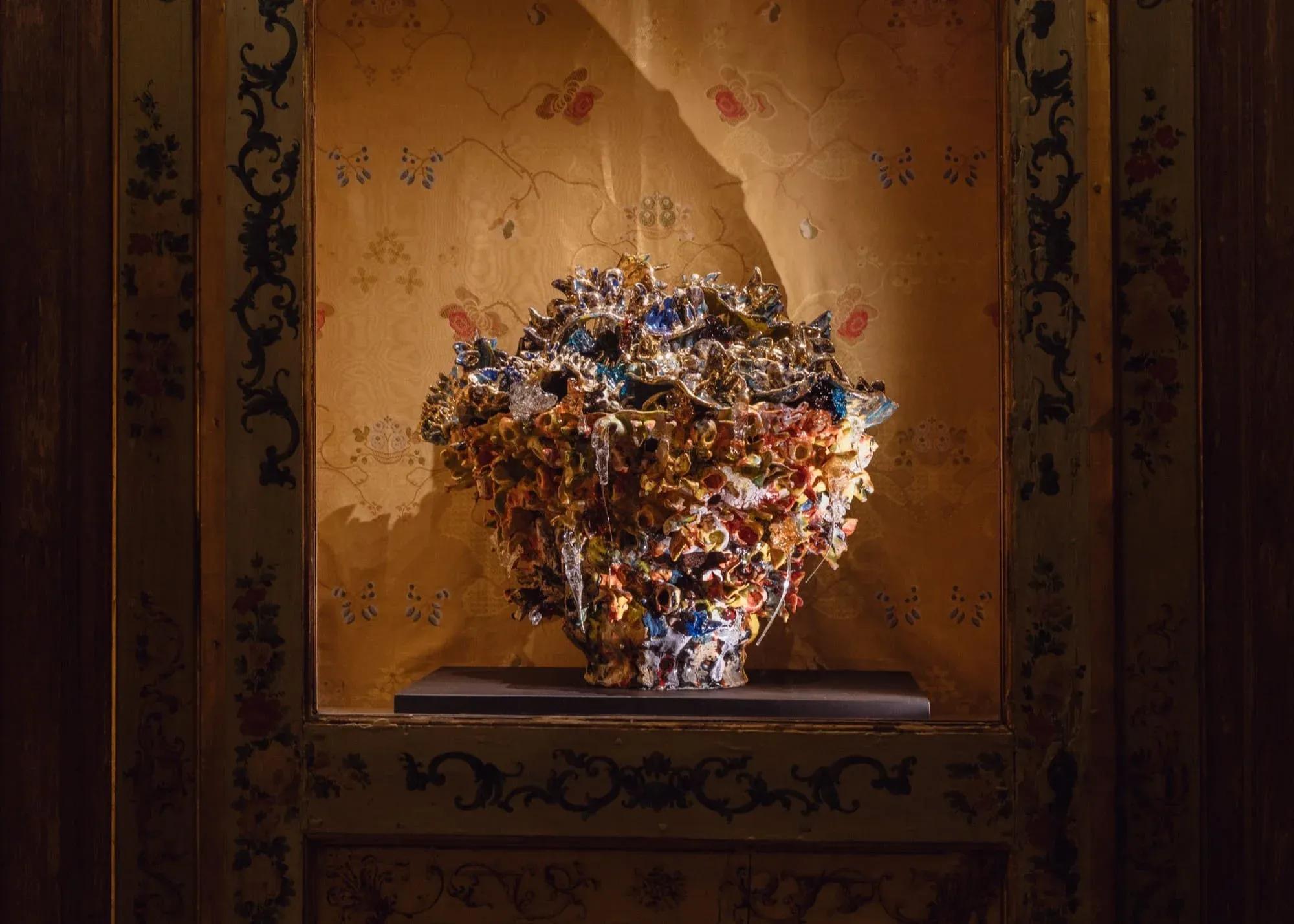 Floral sculpture displayed in a wall niche at the Fondazione Dries Van Noten exhibition