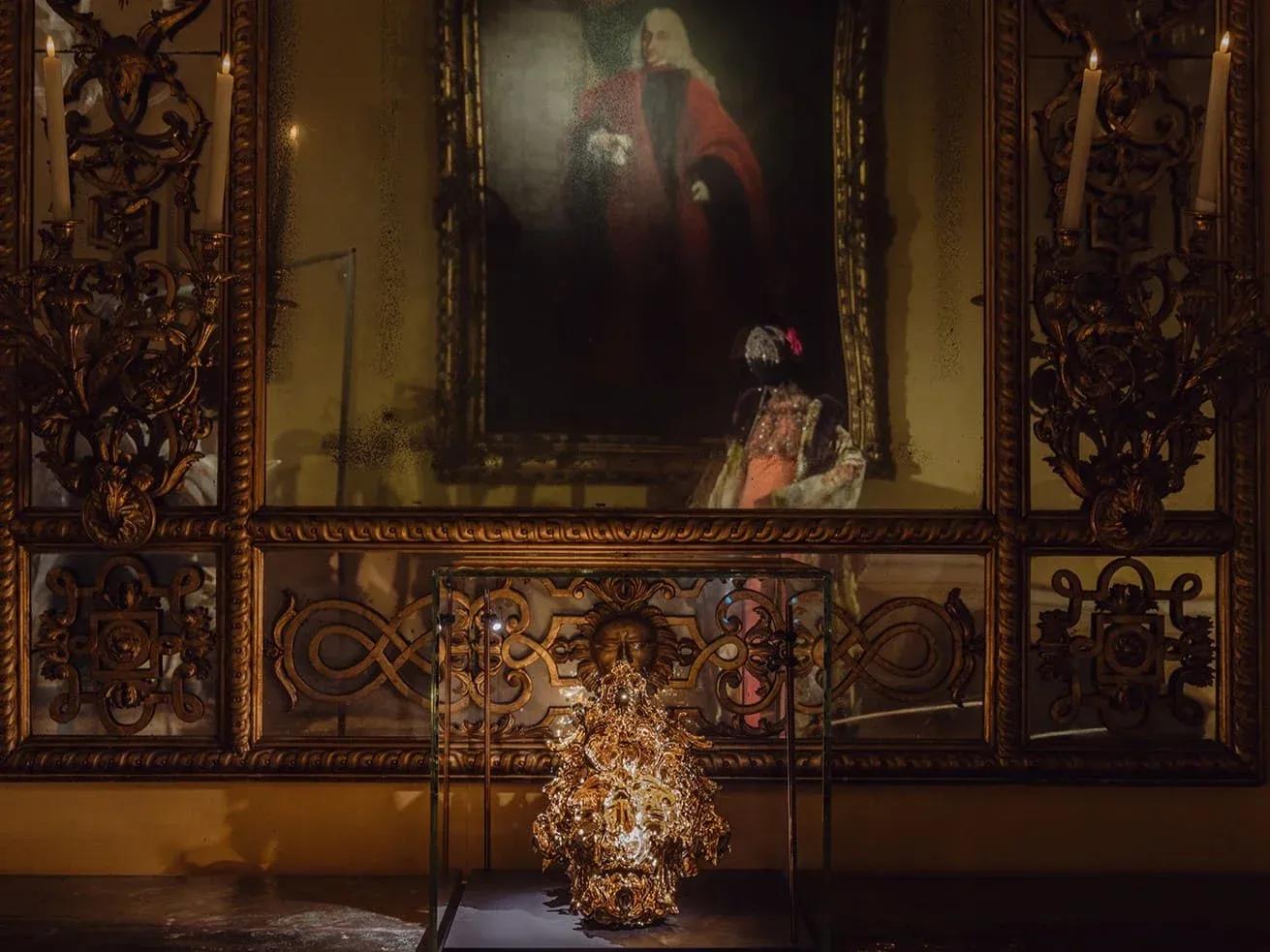 Art installation with sparks in front of a framed painting at the exhibition